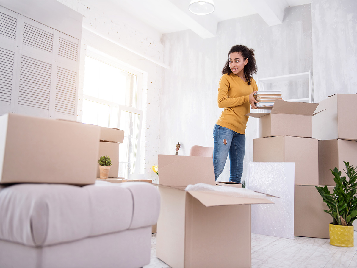 woman packing up boxes in room