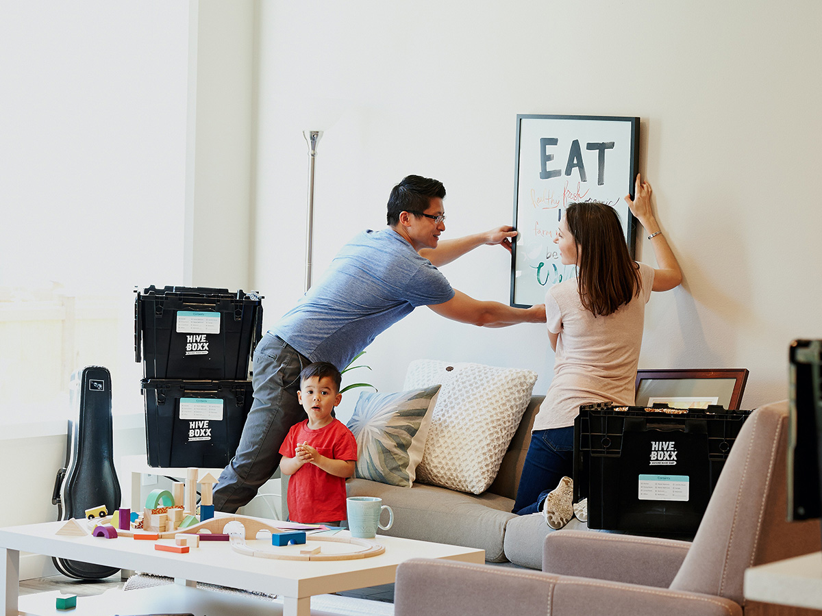 family unpacking living room