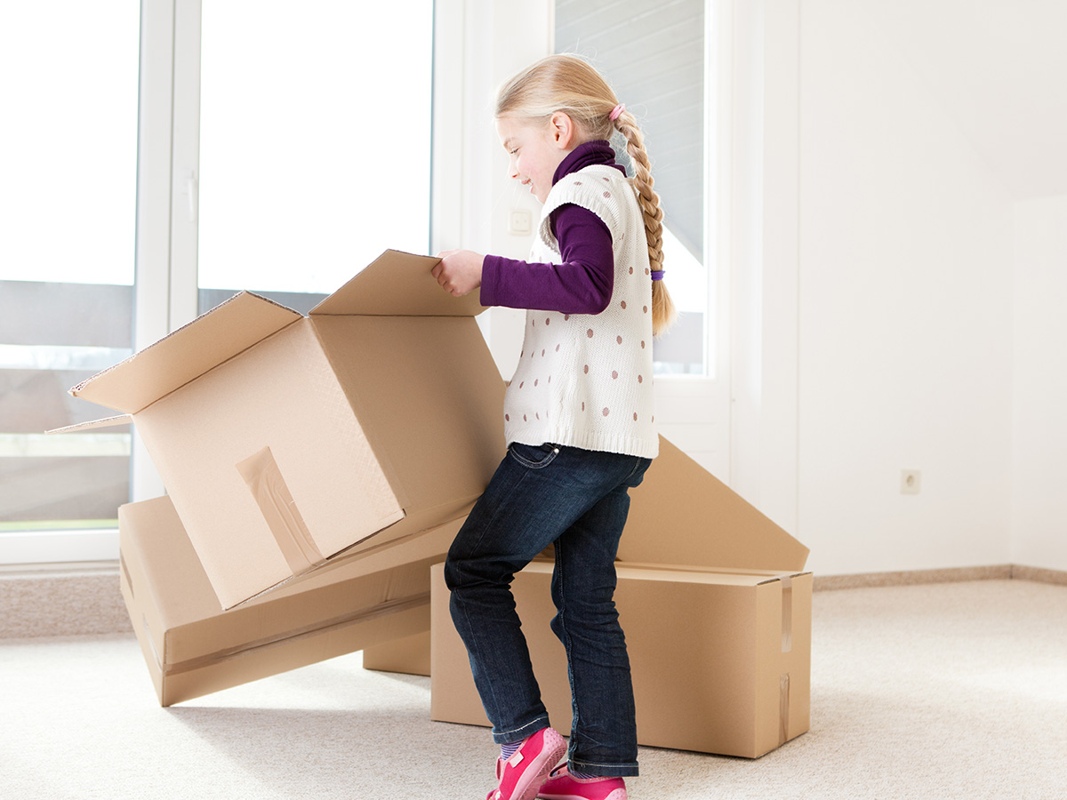 little girl unpacking boxes